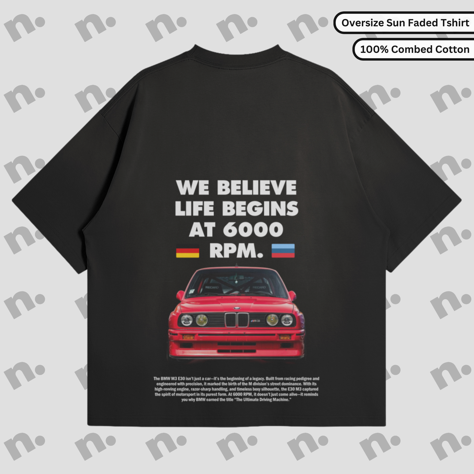 Flat lay of a dark-colored T-shirt featuring a minimalist BMW E30 inspired graphic, paired with modern streetwear accessories on a neutral background.