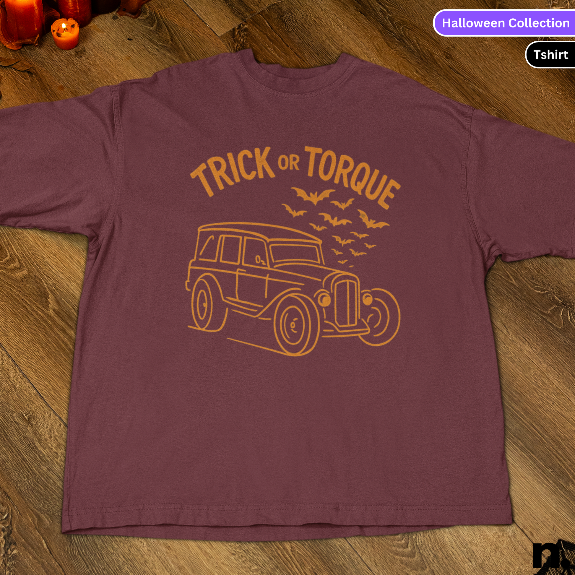 Maroon t-shirt with 'Trick or Torque' design on a wooden surface