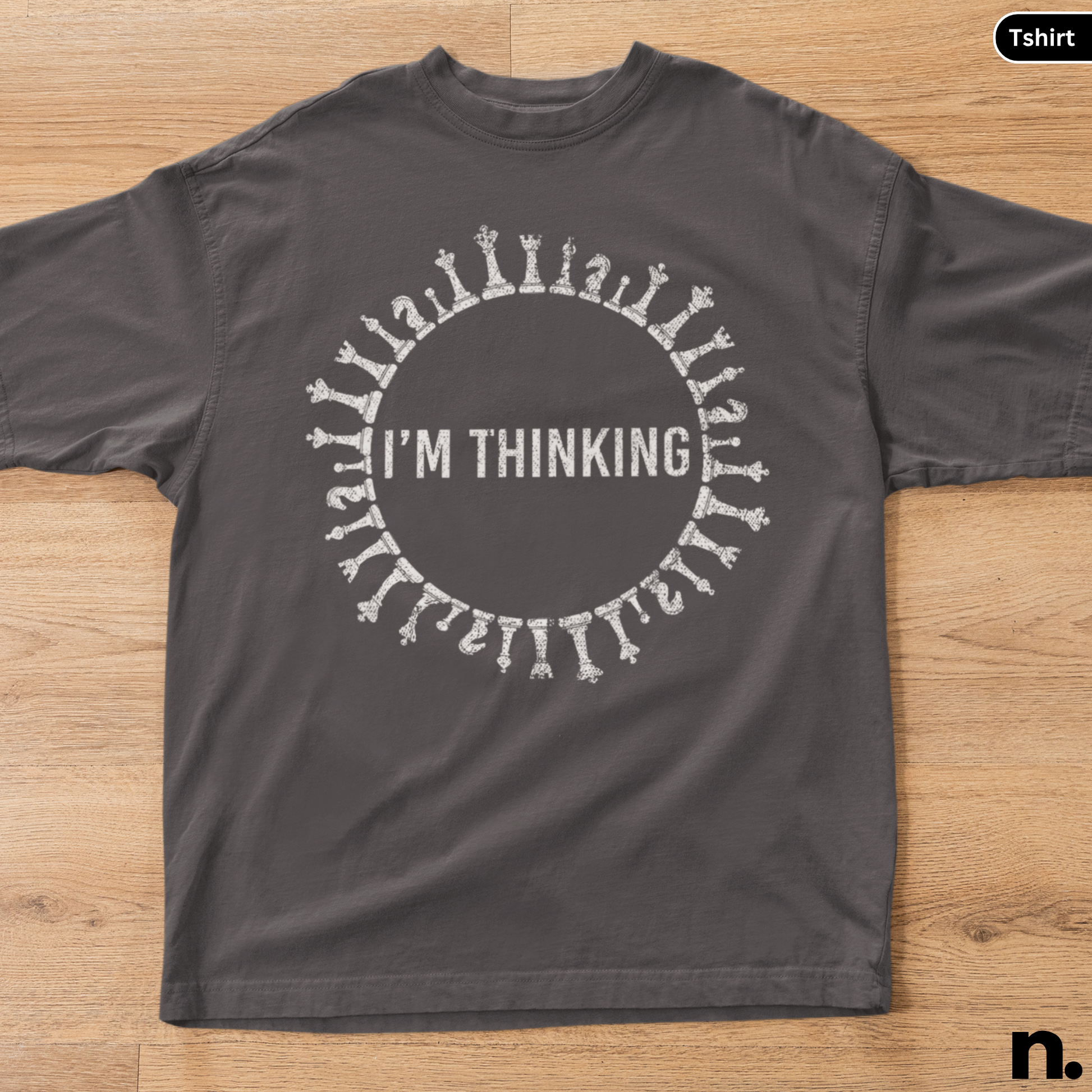 Dark gray t-shirt with 'I'm Thinking' design on a wooden surface