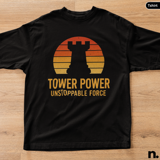 Black t-shirt with 'Tower Power Unstoppable Force' design on a wooden surface