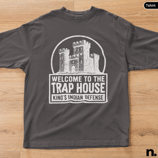 Black t-shirt with a castle graphic and text on a wooden surface