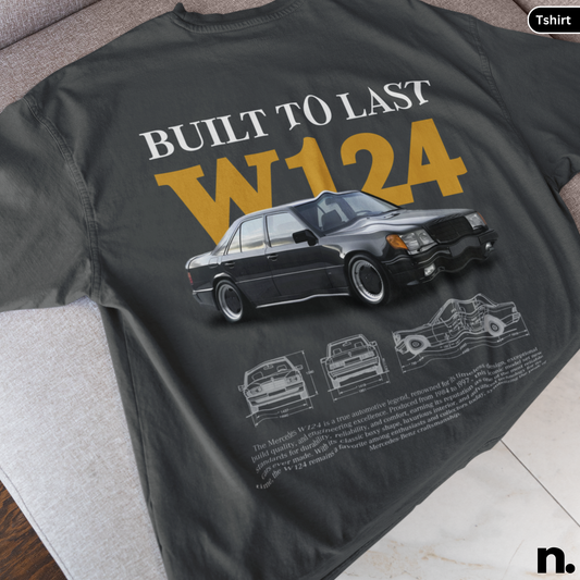 Black t-shirt with car design and text 'Built to Last W124' on a surface.