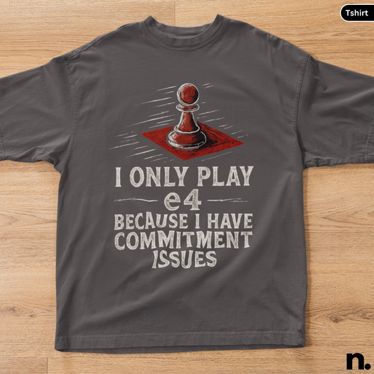 Gray t-shirt with a chess pawn graphic and text on a wooden surface