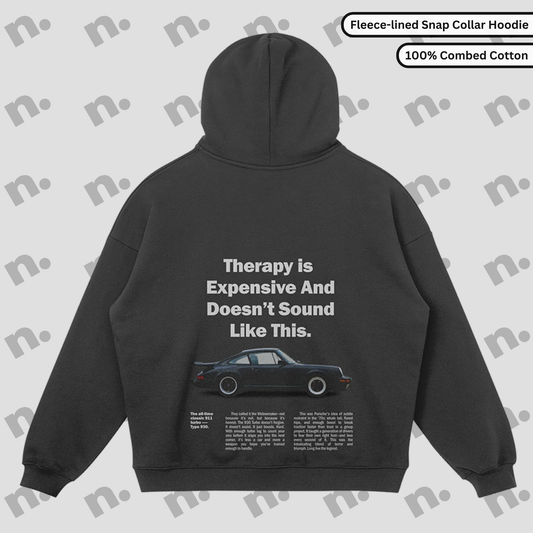 Flat lay of the 911 Therapy Snap Collar Fleece Premium Hoodie featuring a classic 911 graphic and 'Therapy is Expensive' slogan.