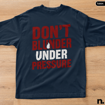 Navy blue t-shirt with red and white text on a wooden surface
