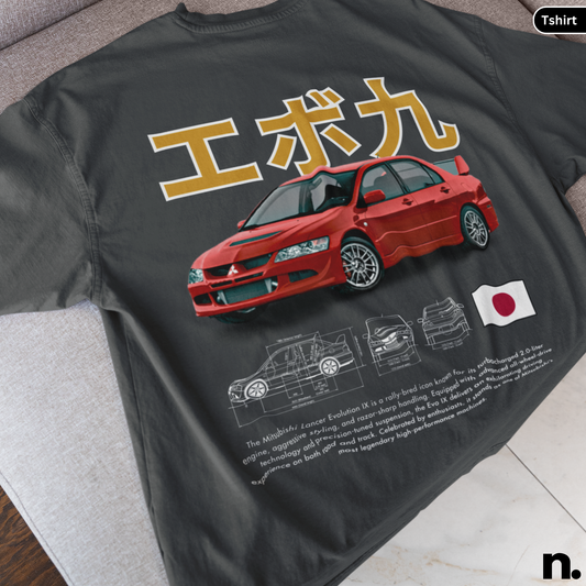 Black t-shirt with red car design, Japanese text, and flag on a gray surface.