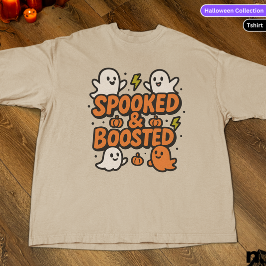 Beige t-shirt with Halloween-themed design featuring ghosts and text on a wooden surface.