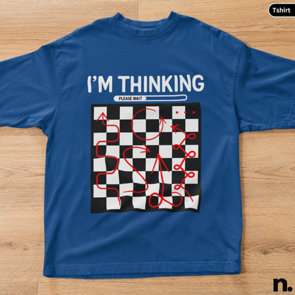 Blue t-shirt with a graphic design and text on a wooden surface