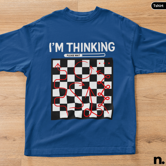 Blue t-shirt with a graphic design and text on a wooden surface