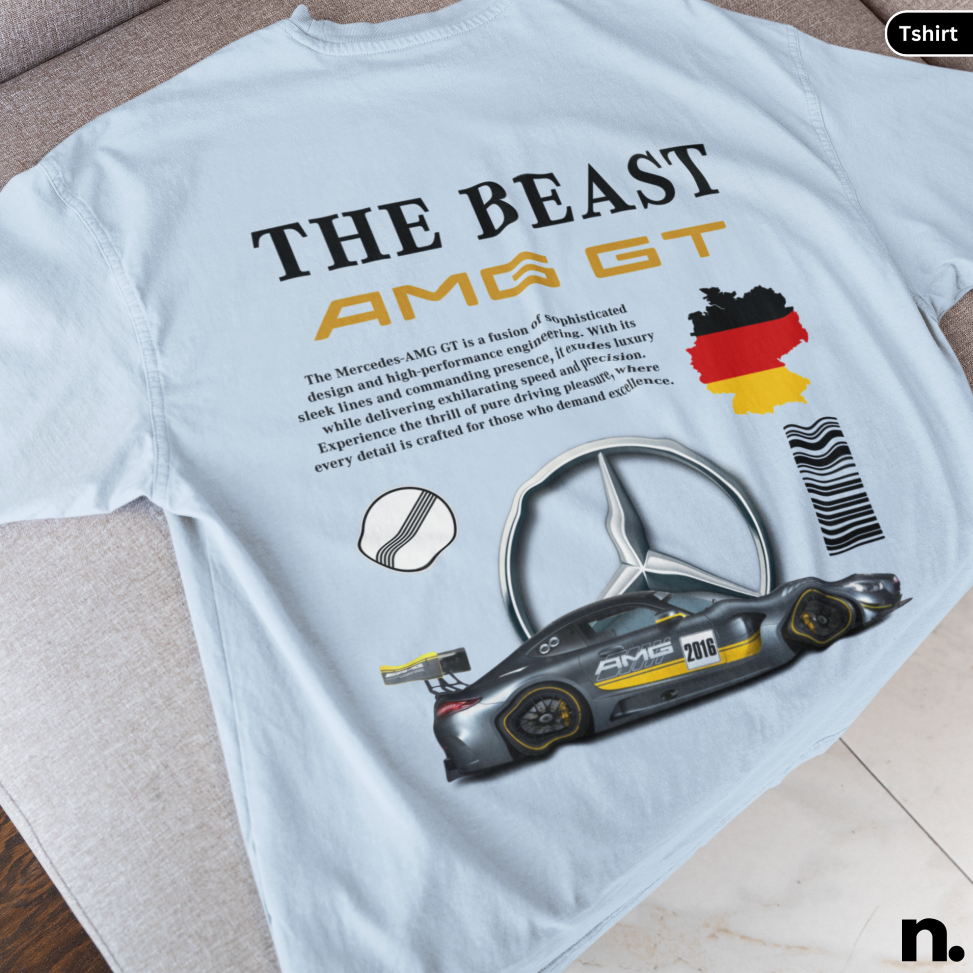 White t-shirt with Mercedes-AMG GT graphic and text on a wooden surface