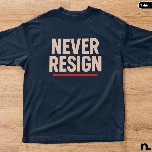 Navy blue t-shirt with 'NEVER RESIGN' text on a wooden surface