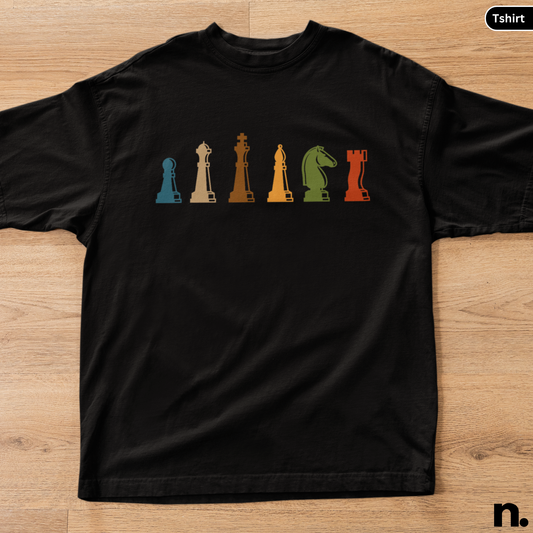 Black t-shirt with colorful chess piece design on a wooden surface