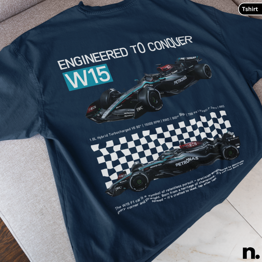Navy blue t-shirt with Formula 1 car design and text 'Engineered to Conquer W15' on a light gray surface.