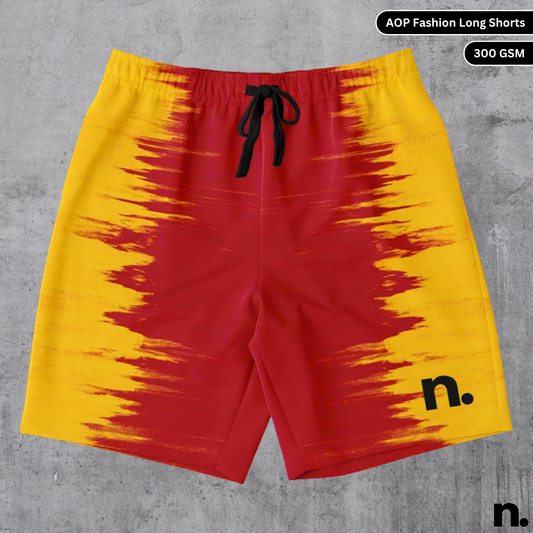 A flat lay of shorts featuring a vivid all-over yellow and red color diffusion pattern, showcasing the drawstring closure and pockets.
