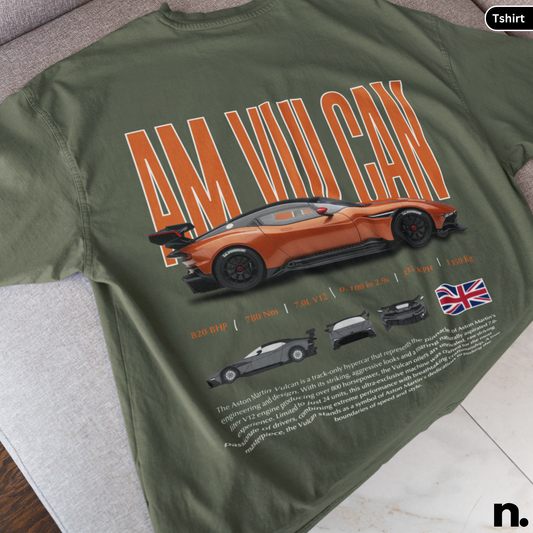 Green t-shirt with orange car graphic and text on a gray surface