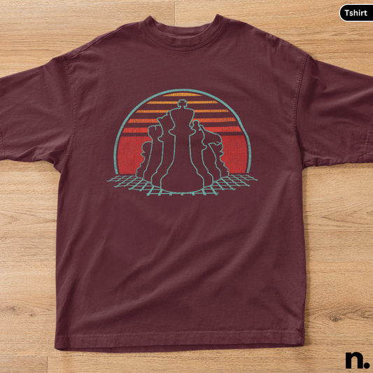 Maroon t-shirt with a graphic design of chess pieces on a wooden surface