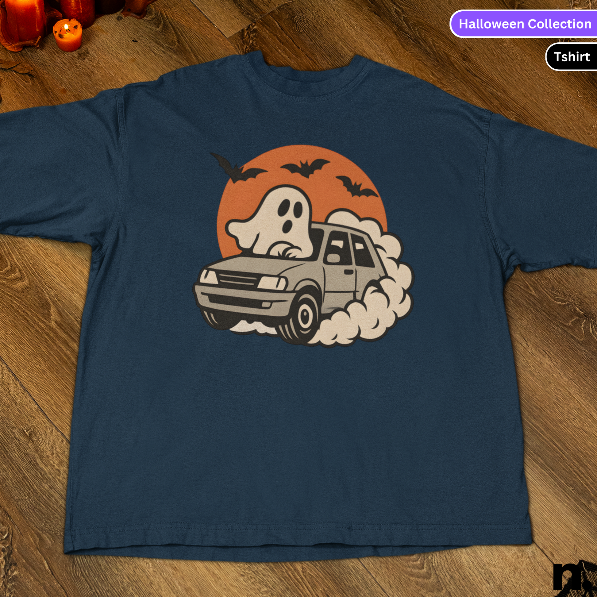 Navy blue t-shirt with a ghost driving a car graphic on a wooden surface