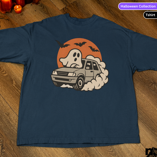 Navy blue t-shirt with a ghost driving a car graphic on a wooden surface