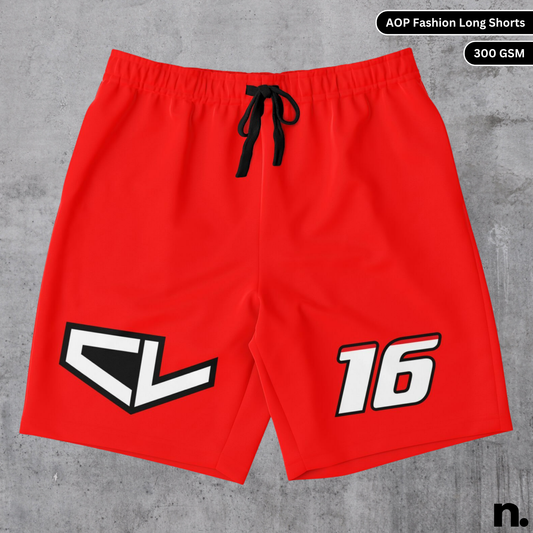 Flat lay of Leclerc-inspired fashion long shorts with red and black racing graphics and F1-style design on a studio background