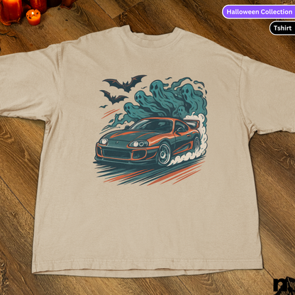 Beige t-shirt with a car graphic and ghost design on a wooden surface