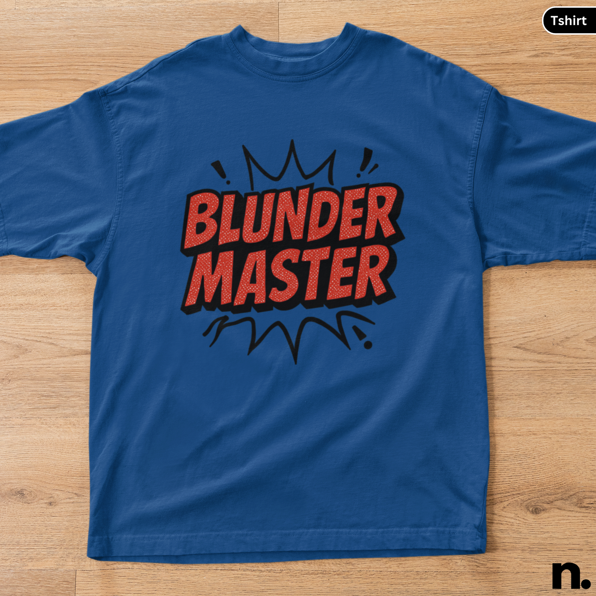 Blue t-shirt with 'BLUNDER MASTER' text on a wooden surface