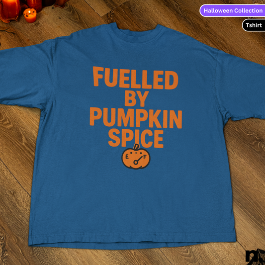 Blue t-shirt with 'Fuelled by Pumpkin Spice' text on a wooden surface