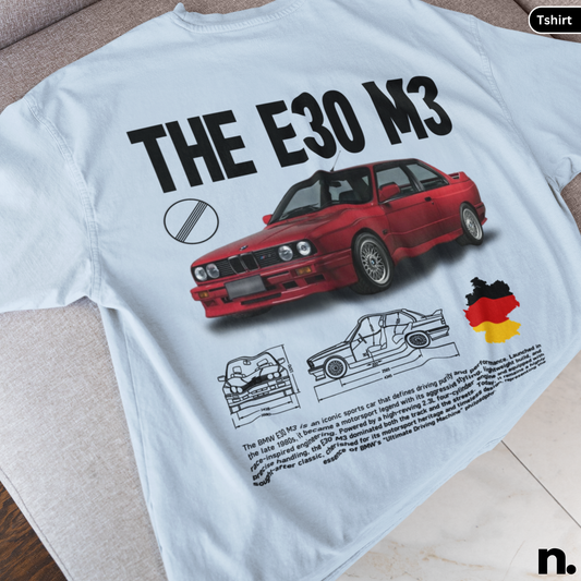 White t-shirt with red BMW E30 M3 graphic and text on a light surface