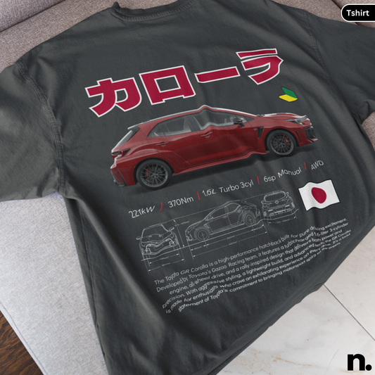 Black t-shirt with red car design and Japanese text on a gray surface