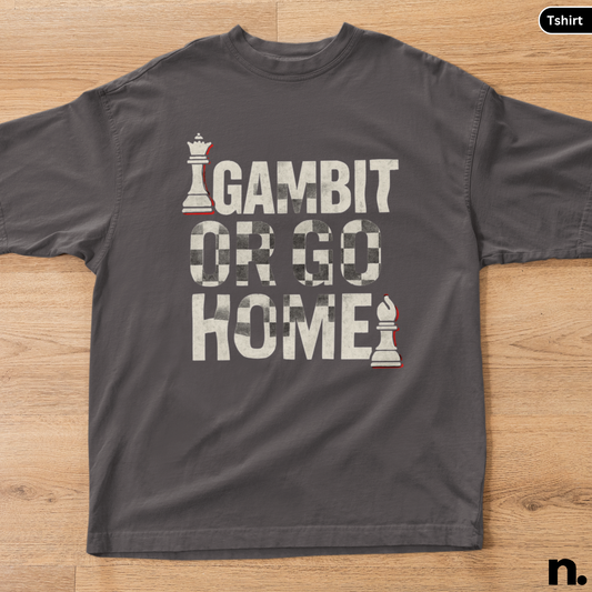 Gray t-shirt with 'Gambit or Go Home' text and chess piece graphics on a wooden surface