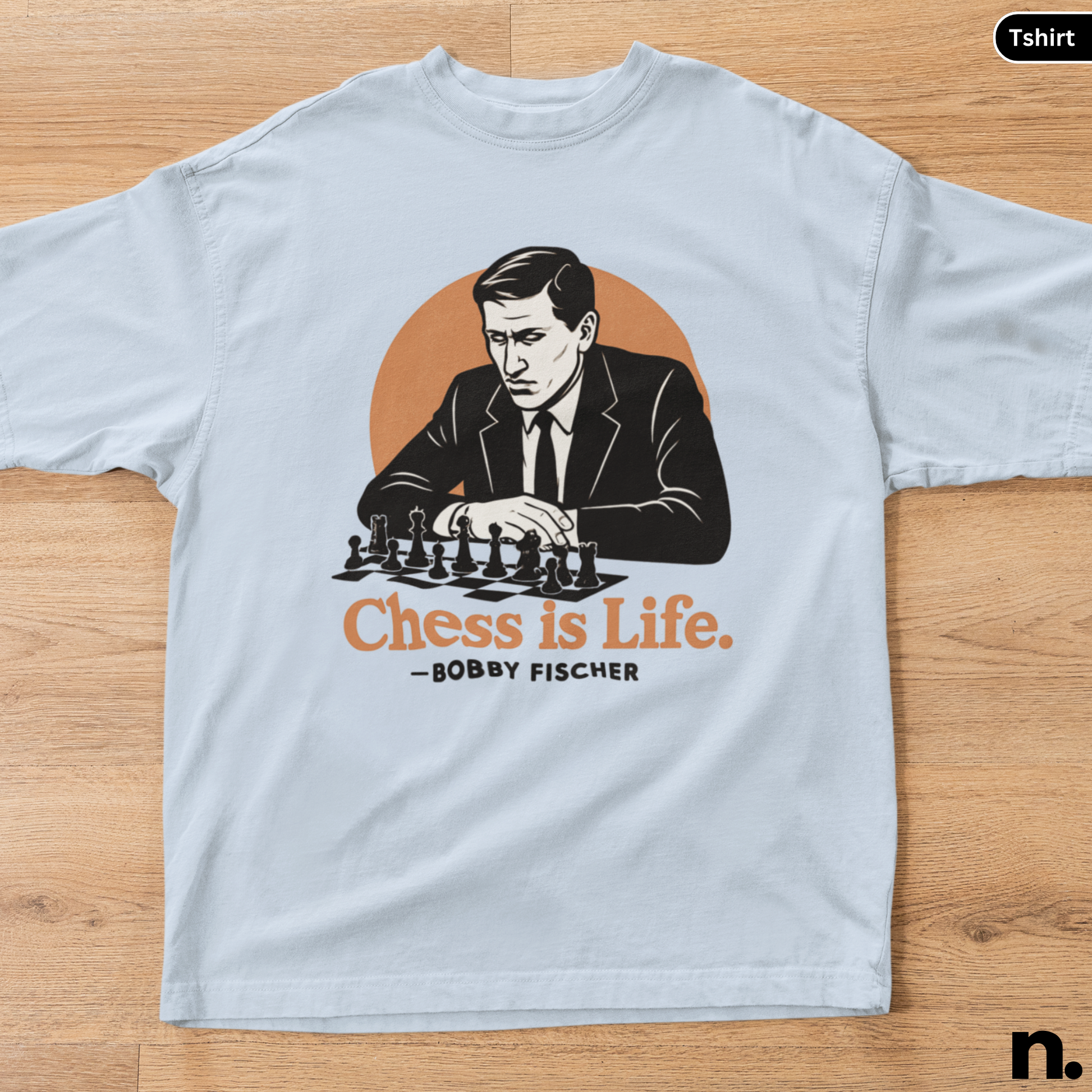 T-shirt with a graphic of a man playing chess and 'Chess is Life' text on a wooden surface