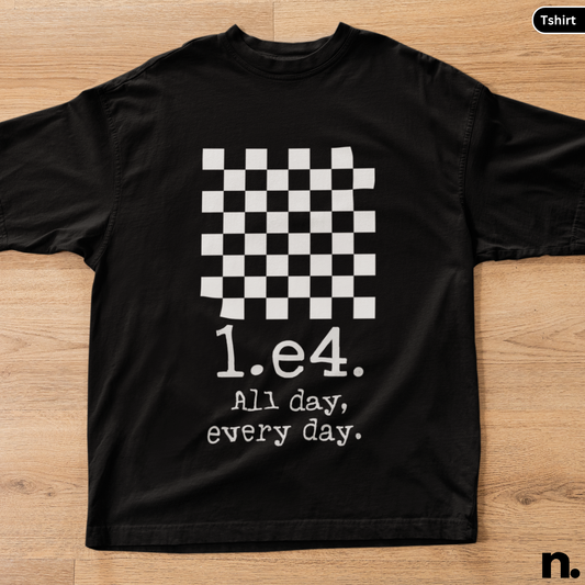 Black t-shirt with a checkered design and text on a wooden surface