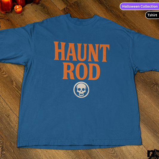 Blue t-shirt with 'HAUNT ROD' text and skull design on a wooden surface.