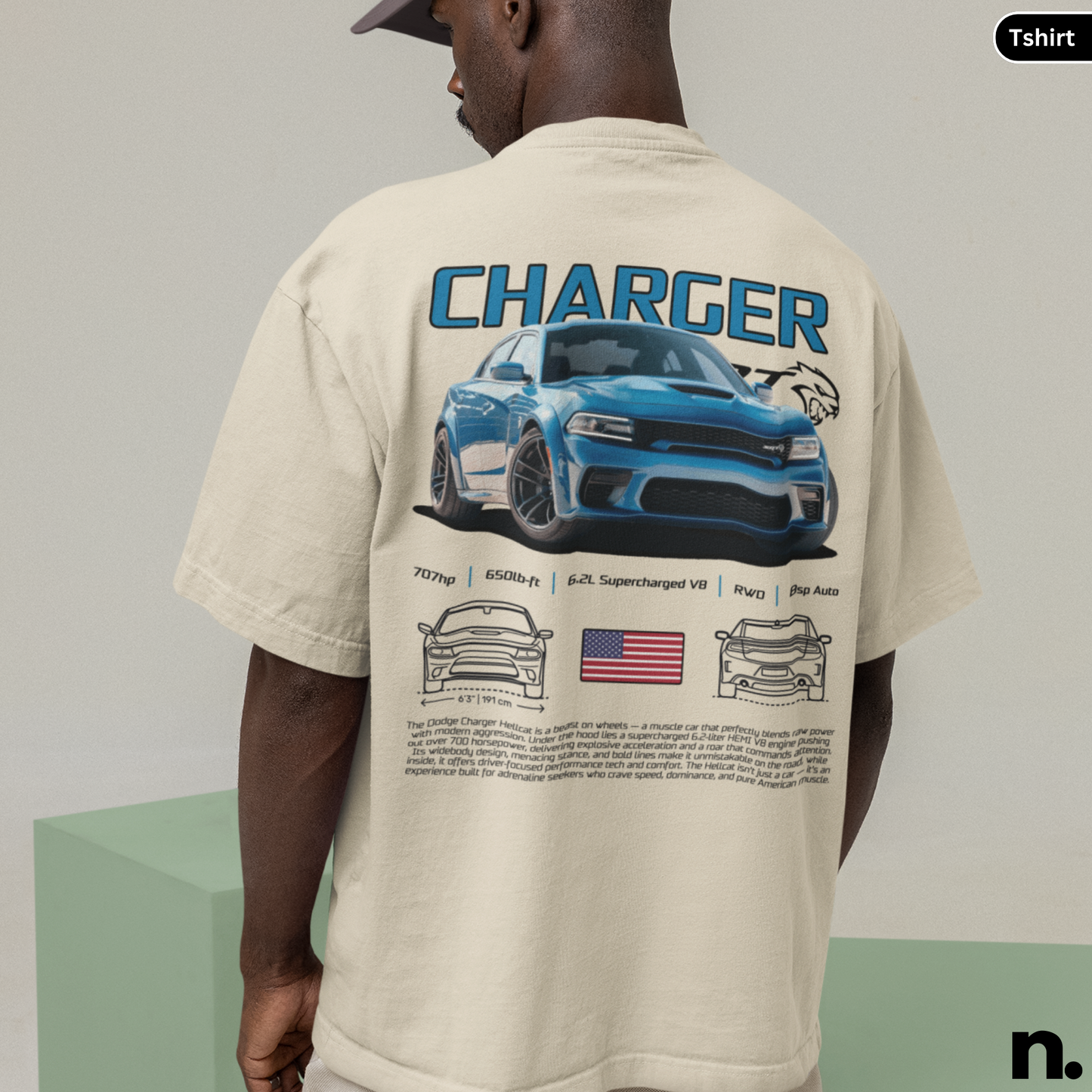 Person wearing a beige t-shirt with a graphic of a blue car and 'CHARGER' text on the back.