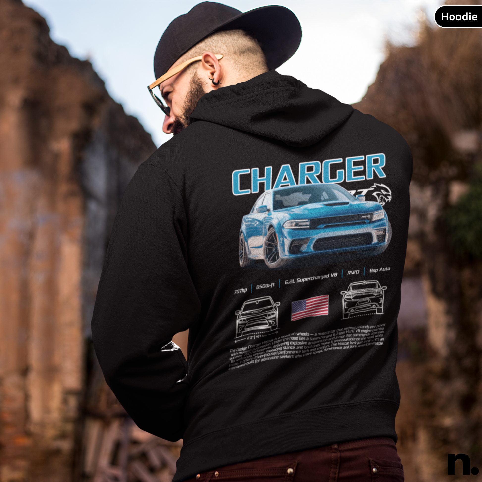 Person wearing a black hoodie with 'Charger' design on the back, standing outdoors.