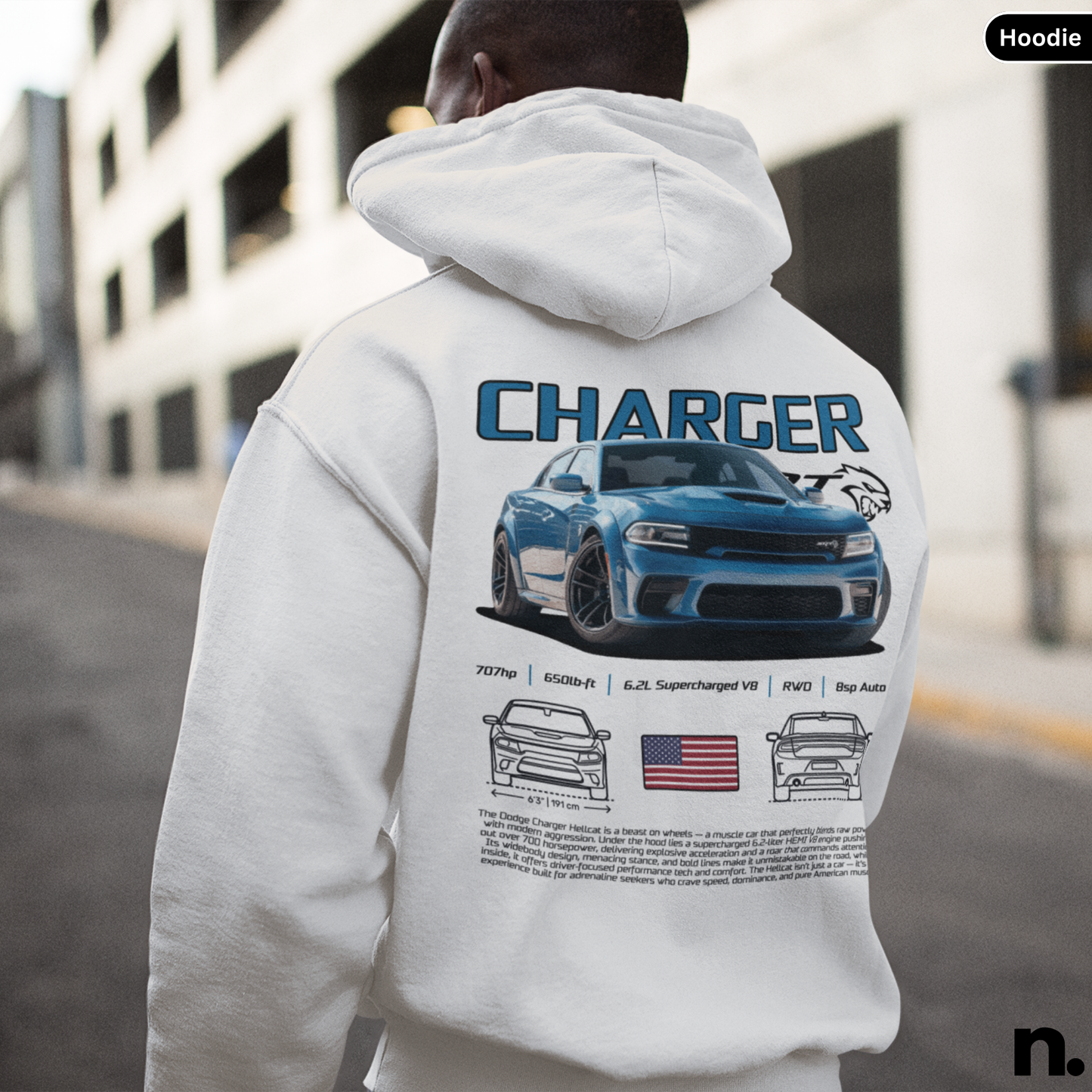 Person wearing a hoodie with a blue car design and 'Charger' text on the back, standing in an urban setting.