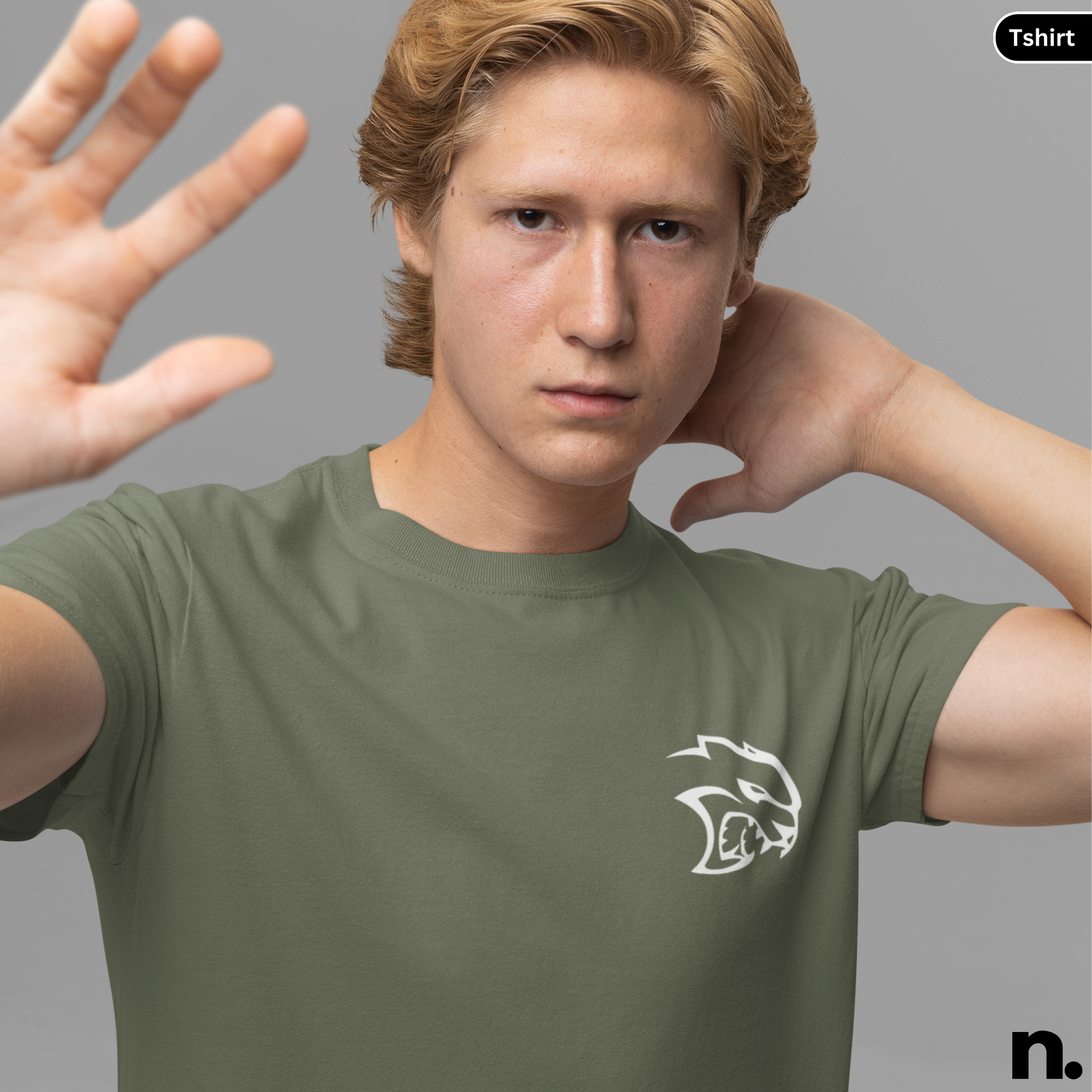 Man wearing a green t-shirt with a logo on a gray background