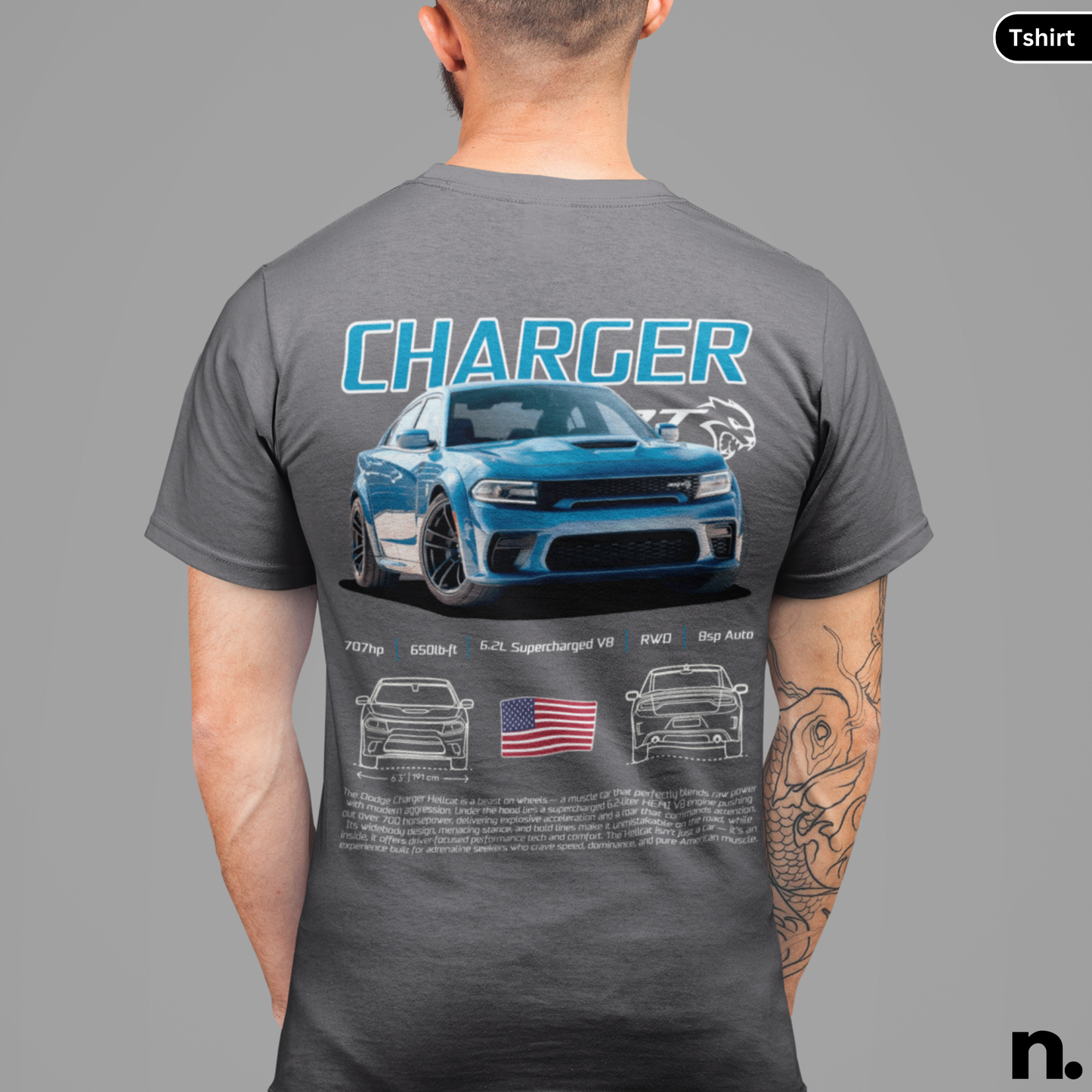 Person wearing a gray t-shirt with a graphic of a blue car and text on the back, on a gray background.