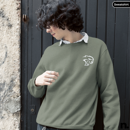 Person wearing a green sweatshirt with a logo, standing against a dark door.