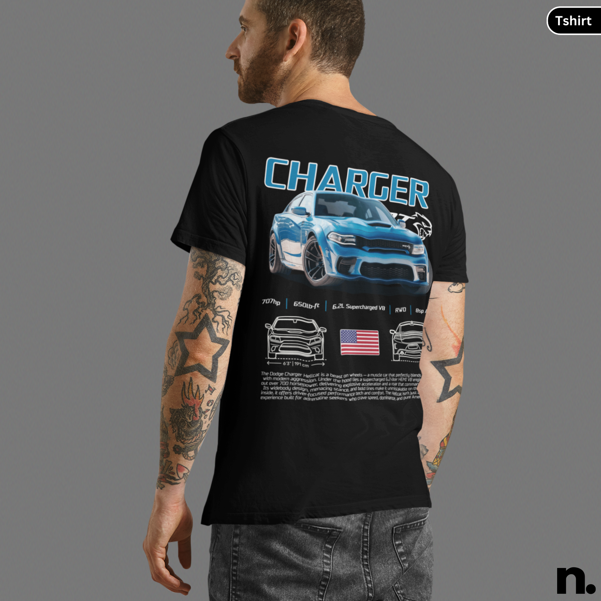Person wearing a black t-shirt with a graphic design of a car and text on the back, on a gray background.