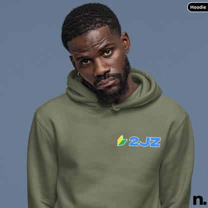 Man wearing a green hoodie with '2JZ' logo against a blue background