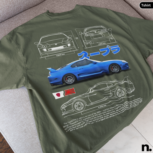 Green t-shirt with blue car graphic and Japanese text on a gray surface
