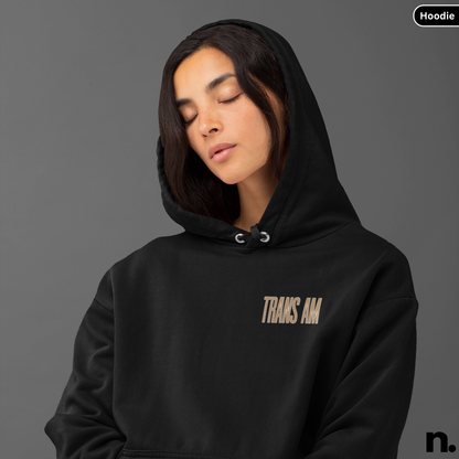 Person wearing a black hoodie with 'TRANS AM' text on a gray background