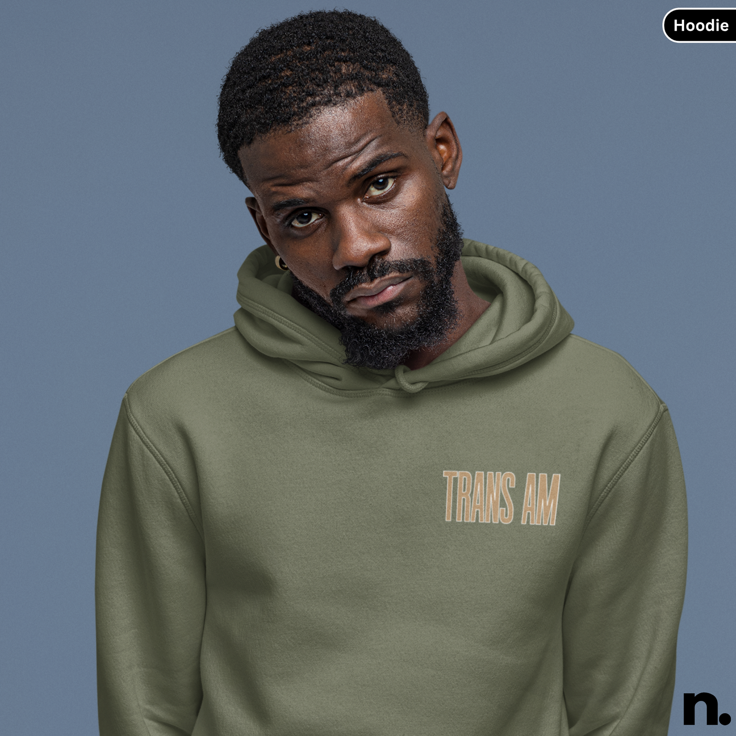 Man wearing a green hoodie with 'TRANS AM' text on a blue background