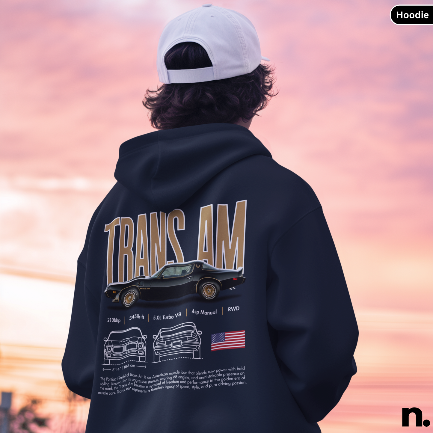 Person wearing a hoodie with 'TRANS AM' design against a sunset sky