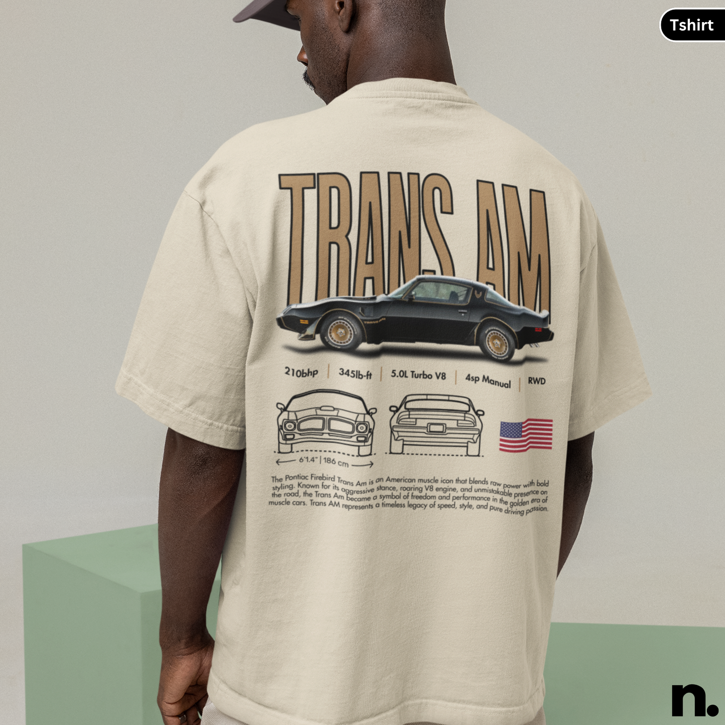 Person wearing a beige t-shirt with 'TRANS AM' graphic design on the back.