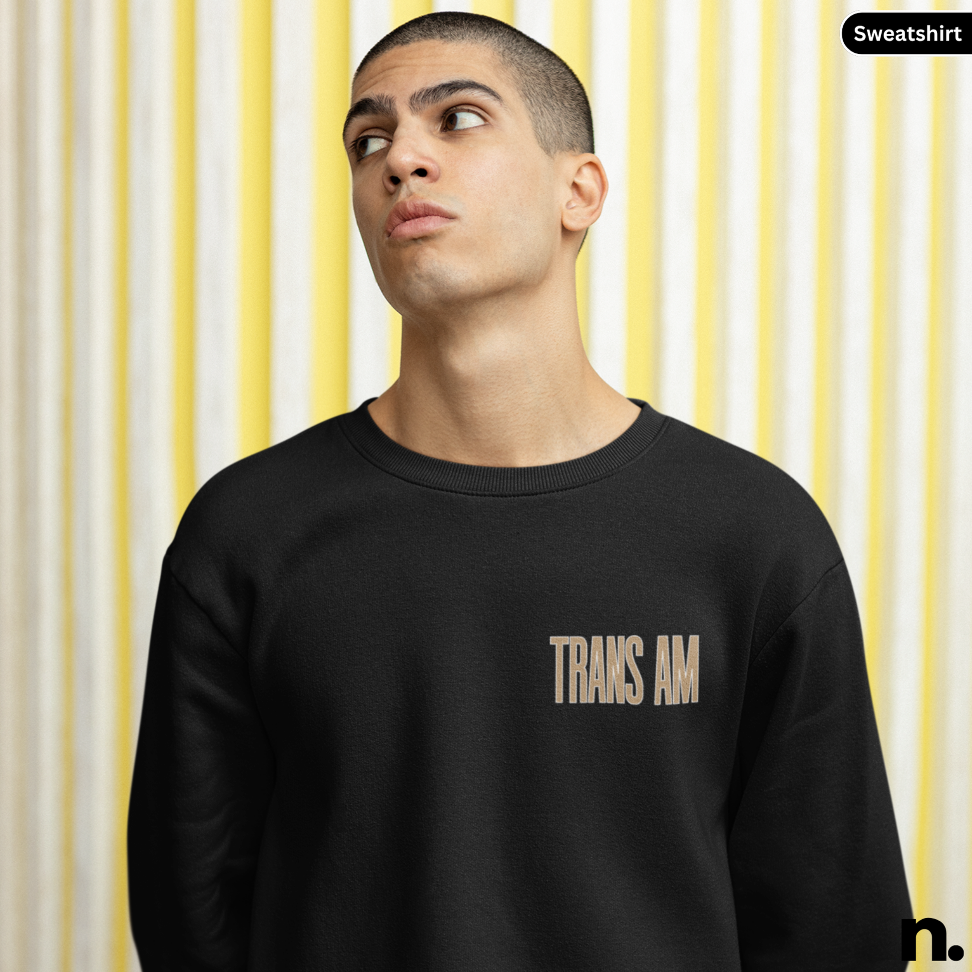 Person wearing a black sweatshirt with 'TRANS AM' text against a striped background